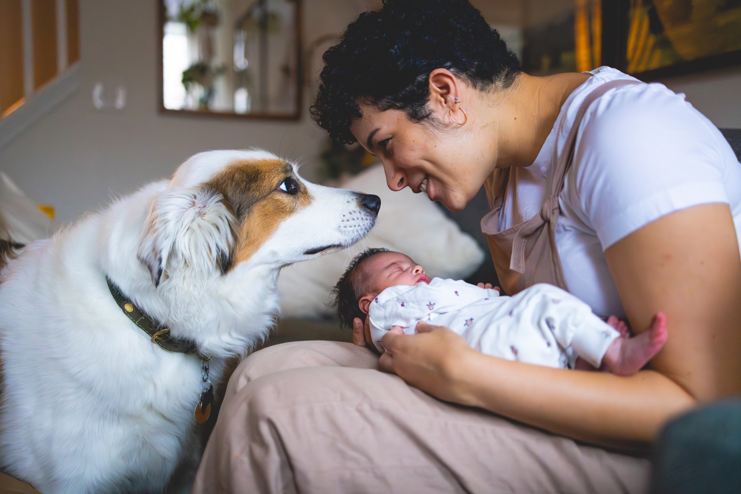 mother with newborn baby and dog